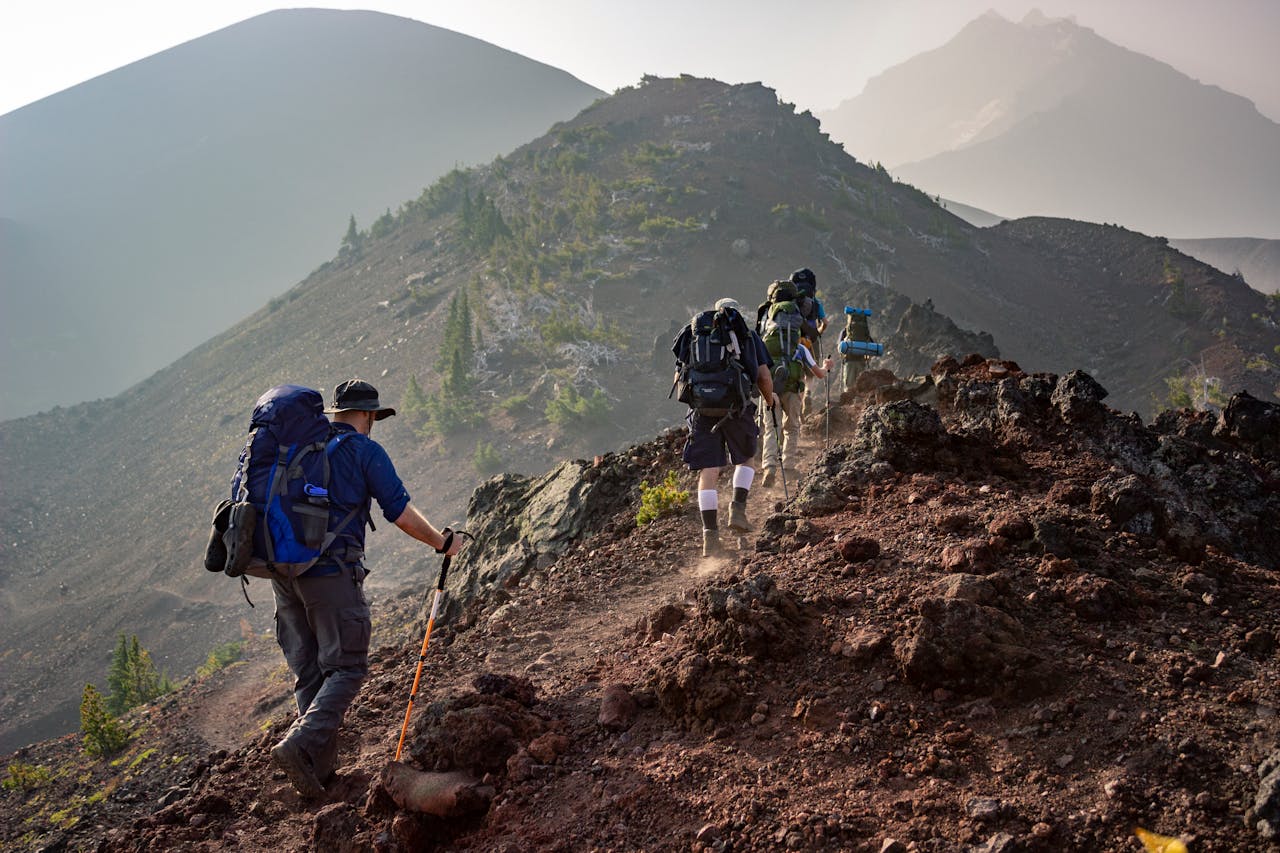 services-01 Group of hikers trekking on a rugged mountain trail in Oregons scenic outdoors.